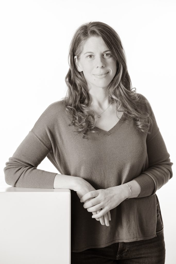 Hebamme Lisa Waglechner steht mit dem rechten Ellbogen auf ein Podest abgestützt